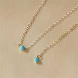 sautoir de dos dore avec perles turquoises