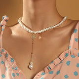   collier pour dos trio de perles nacrées 